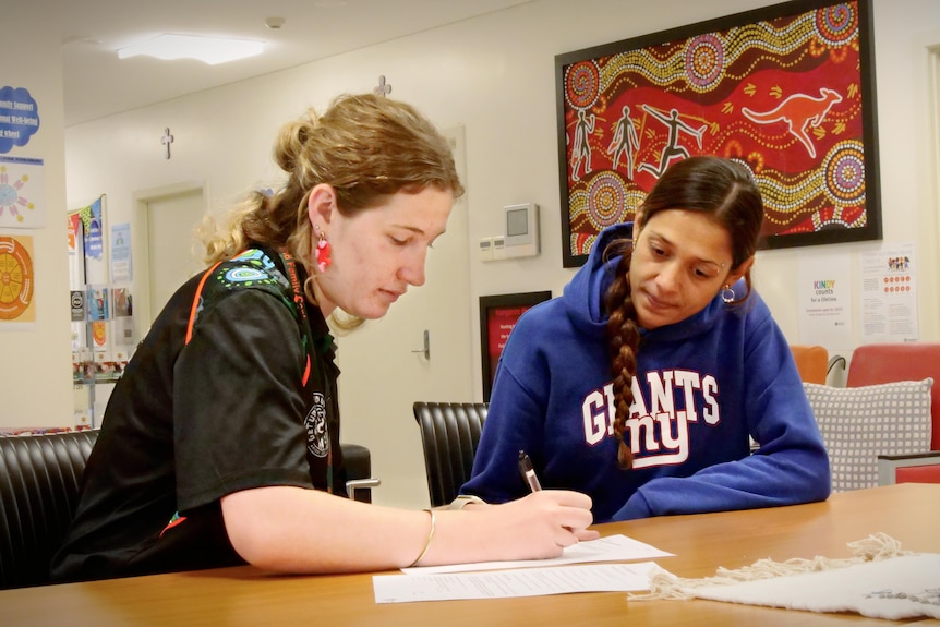 support worker helps aboriginal woman to get her birth certificate