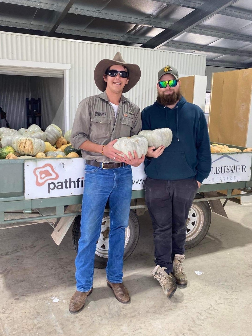 Two man holding pumpkins from Tilbuster station