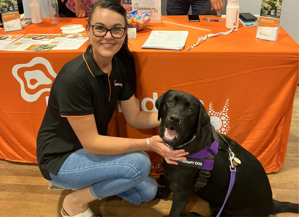 Pathfinders Support worker with support dog at Living Well Expo Coffs Harbour